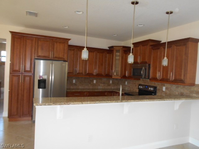 18225 Poplar Road Fort Myers, FL 33967 - Photo 17 of 21 a view of a kitchen with a refrigerator a sink and cabinets