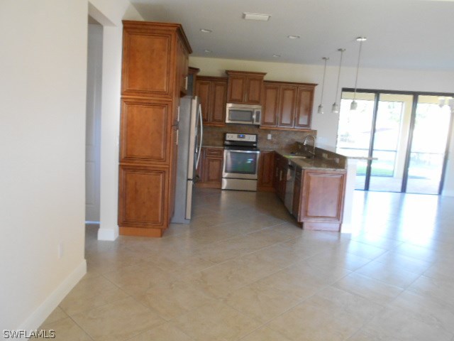 18225 Poplar Road Fort Myers, FL 33967 - Photo 18 of 21 a kitchen with stainless steel appliances granite countertop a refrigerator and a stove top oven