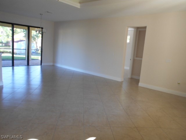 18225 Poplar Road Fort Myers, FL 33967 - Photo 19 of 21 an empty room with wooden floor and windows