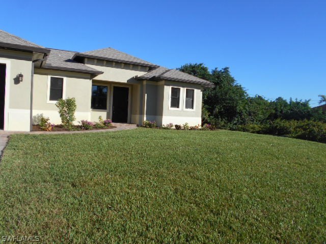 18225 Poplar Road Fort Myers, FL 33967 - Photo 2 of 21 a front view of a house with a yard