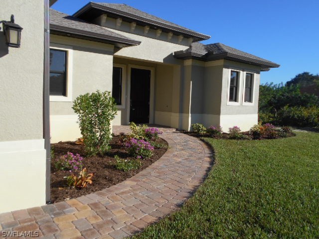 18225 Poplar Road Fort Myers, FL 33967 - Photo 5 of 21 a front view of house with a garden