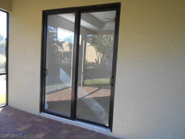 18225 Poplar Road Fort Myers, FL 33967 - Photo 7 of 21 an empty room with a glass door and garden