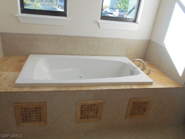 18225 Poplar Road Fort Myers, FL 33967 - Photo 10 of 21 a bathroom with a bathtub