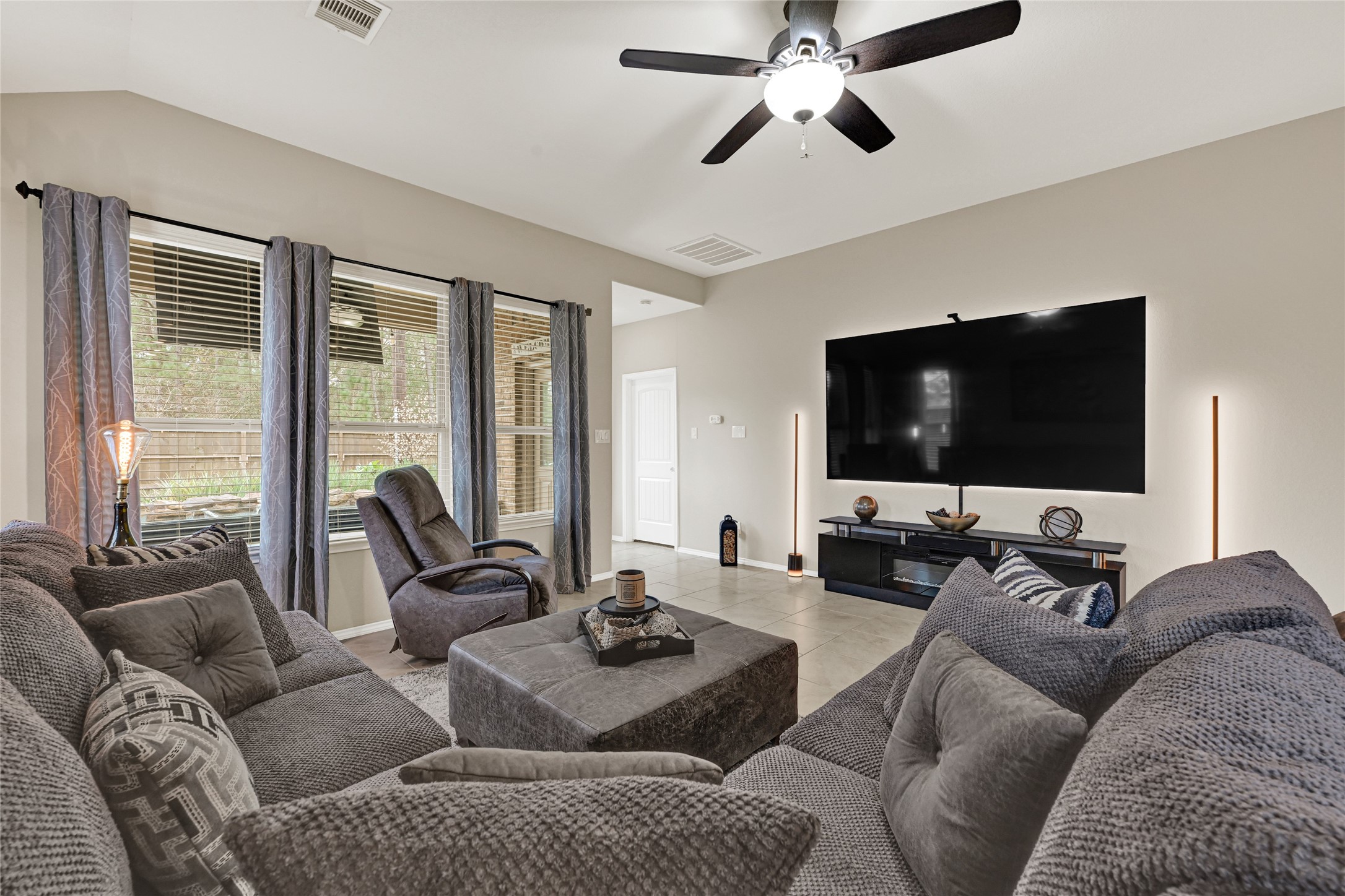 24303 Ravenna Landing Loop Spring, TX 77389 - Photo 16 of 46 a living room with furniture and a flat screen tv