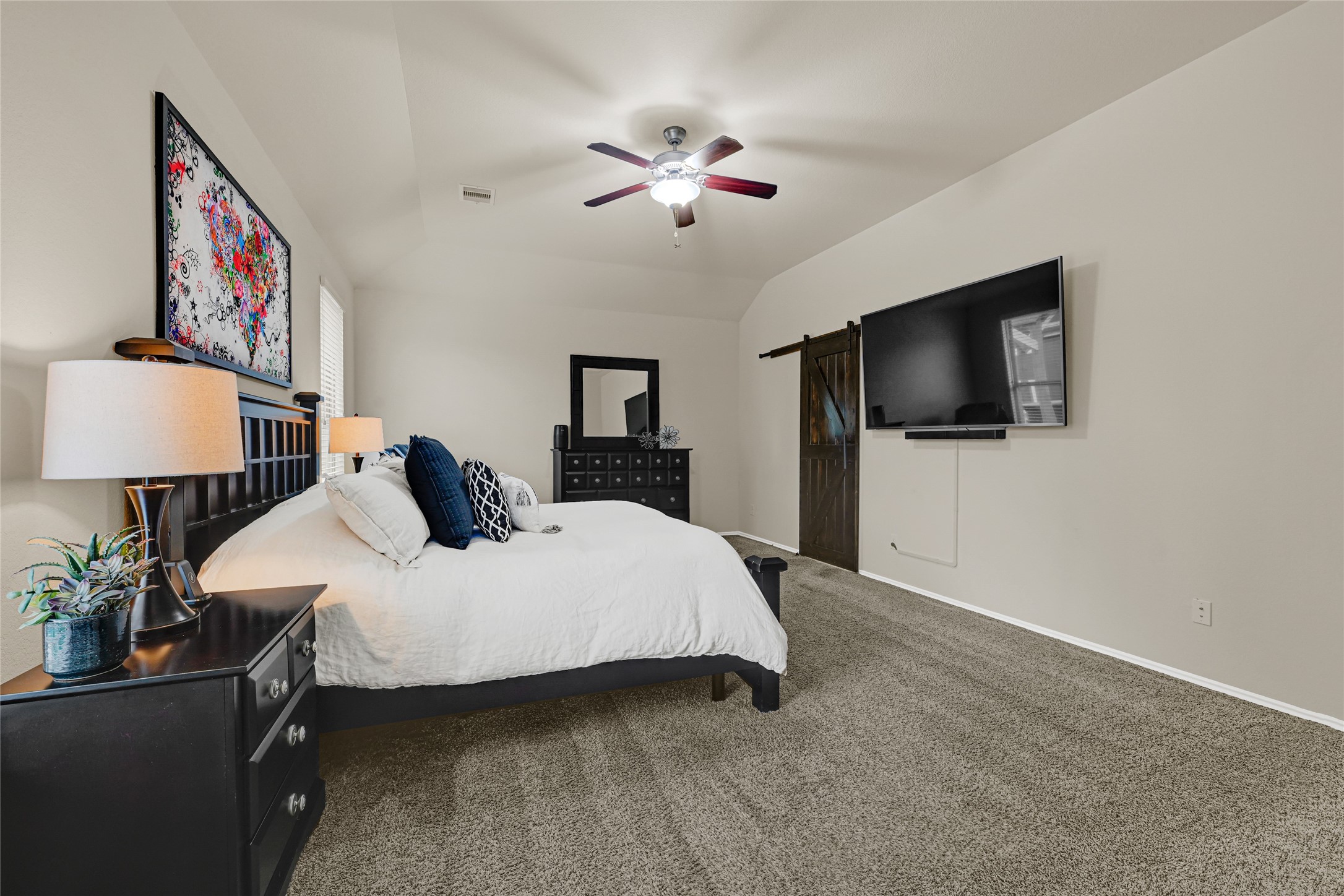 24303 Ravenna Landing Loop Spring, TX 77389 - Photo 22 of 46 a bedroom with a bed and a flat screen tv