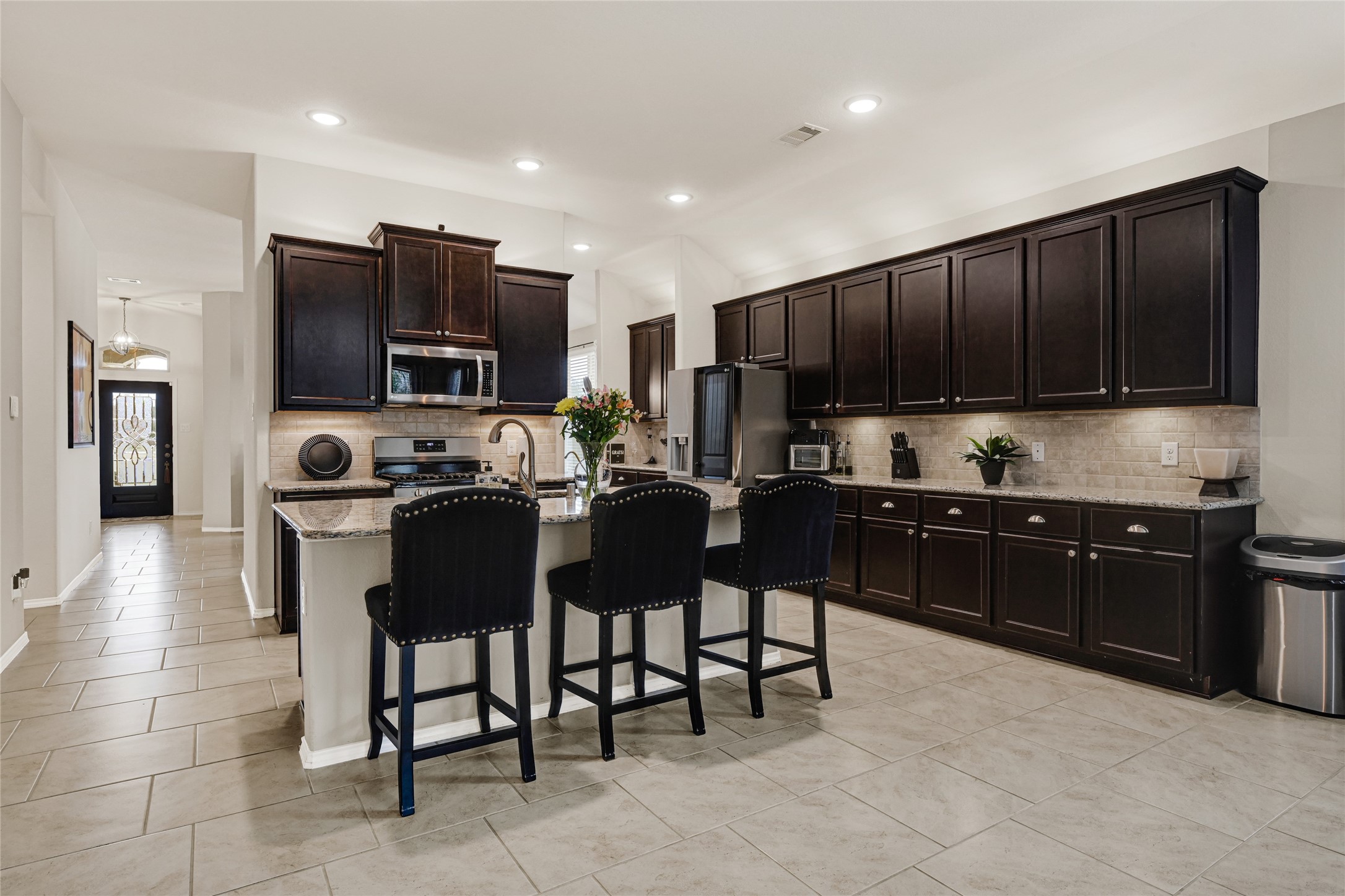 24303 Ravenna Landing Loop Spring, TX 77389 - Photo 10 of 46 a kitchen with stainless steel appliances granite countertop a stove a sink a microwave a refrigerator and cabinets