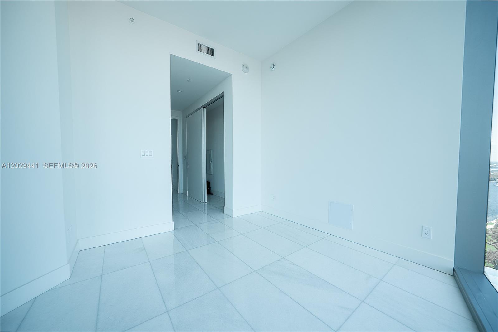 175 Southeast 25th Road, Unit 2103 Miami, FL 33129 - Photo 8 of 27 a view of an empty room with closet and mirror