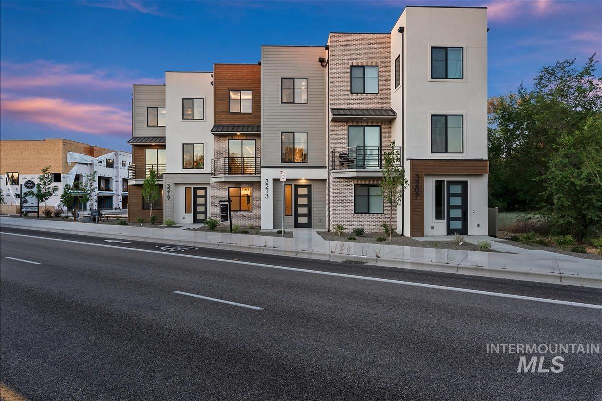 3213 West Moore Street Boise, ID 83702 - Photo 1 of 32 Modern multi-story facade featuring varied siding materials, black-framed windows, and individual balconies