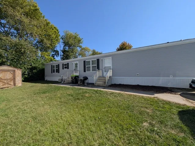 a view of a house with backyard and sitting area