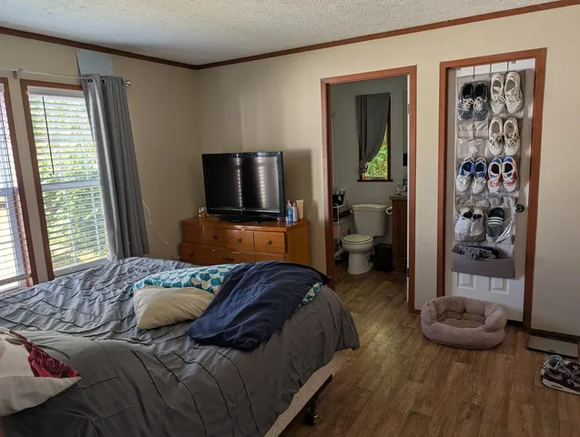 a bedroom with a bed and a tv