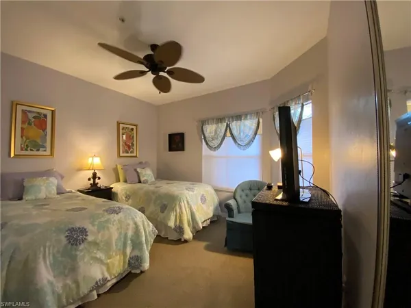 a bedroom with double bed and a window