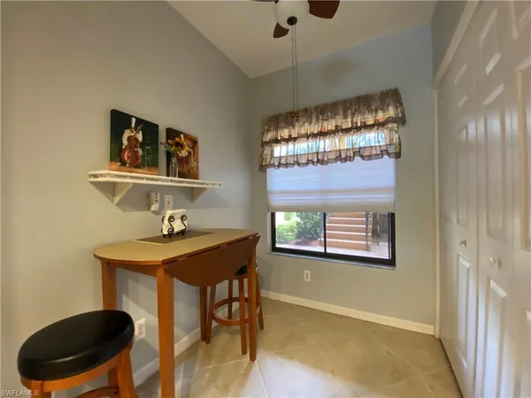 a view of a livingroom with furniture and a window