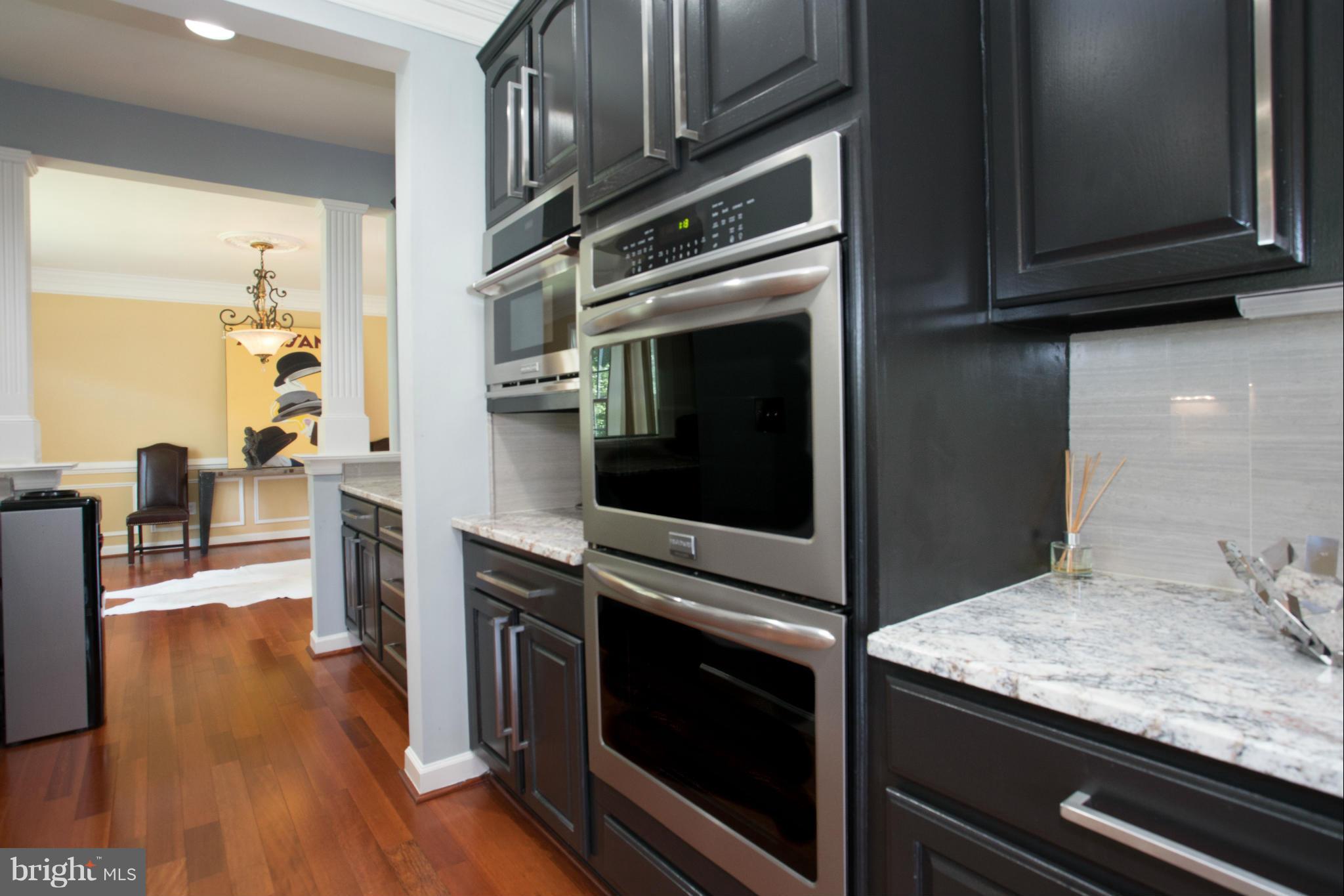 2302 Parlor Court Fallston, MD 21047 - Photo 11 of 30 a kitchen with granite countertop a stove and a microwave oven