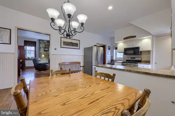 a kitchen with stainless steel appliances a sink a stove top oven a counter space and cabinets