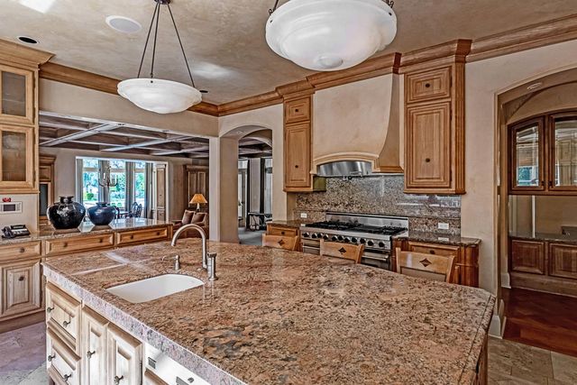 a living room with furniture a fireplace and a table