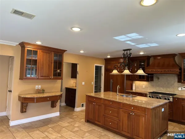 a kitchen with stainless steel appliances granite countertop a stove and a sink