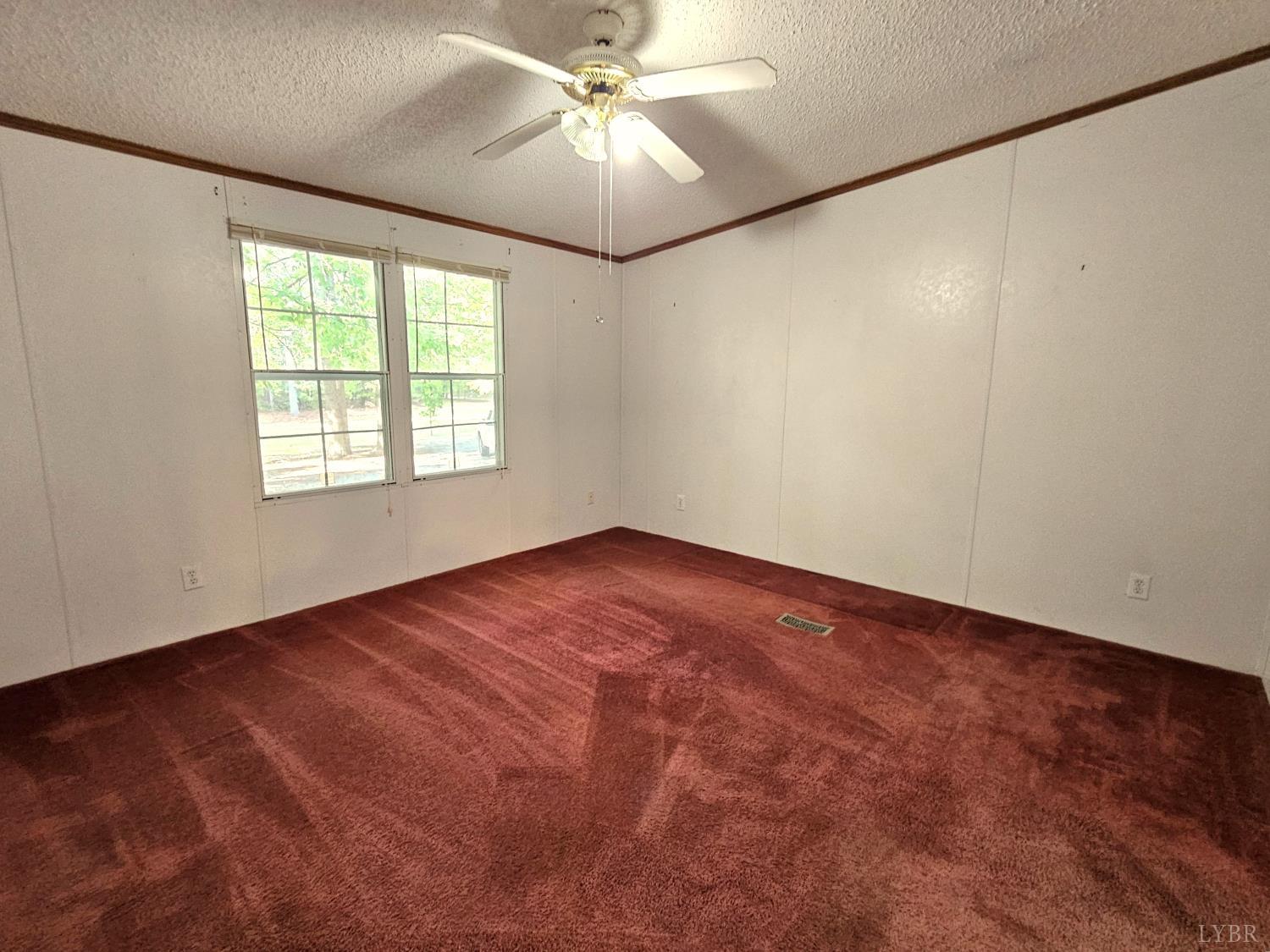 7962 Five Forks Road Farmville, VA 23901 - Photo 14 of 29 an empty room with a window and a fan