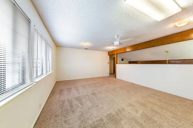 a view of an empty room and a window