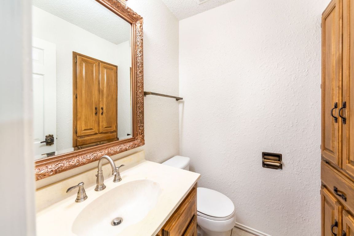 8501 Fathom Circle, Unit A Austin, TX 78750 - Photo 15 of 30 a bathroom with a sink vanity mirror and toilet