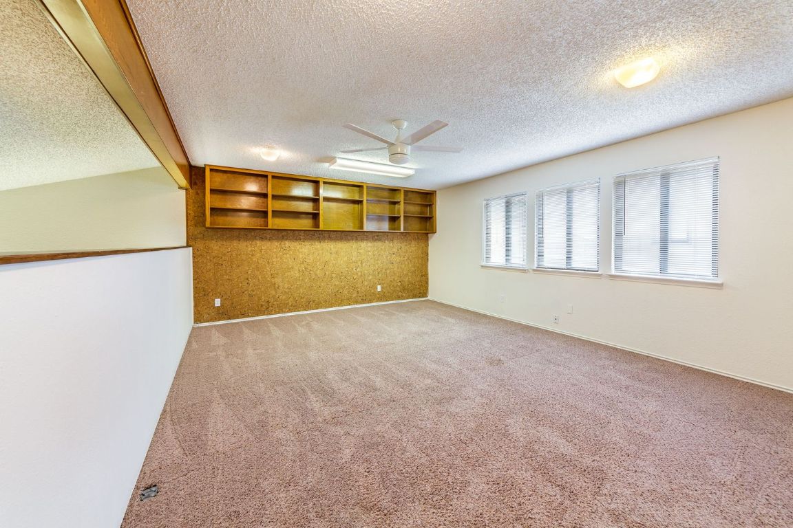 8501 Fathom Circle, Unit A Austin, TX 78750 - Photo 16 of 30 en empty room with windows and ceiling fan