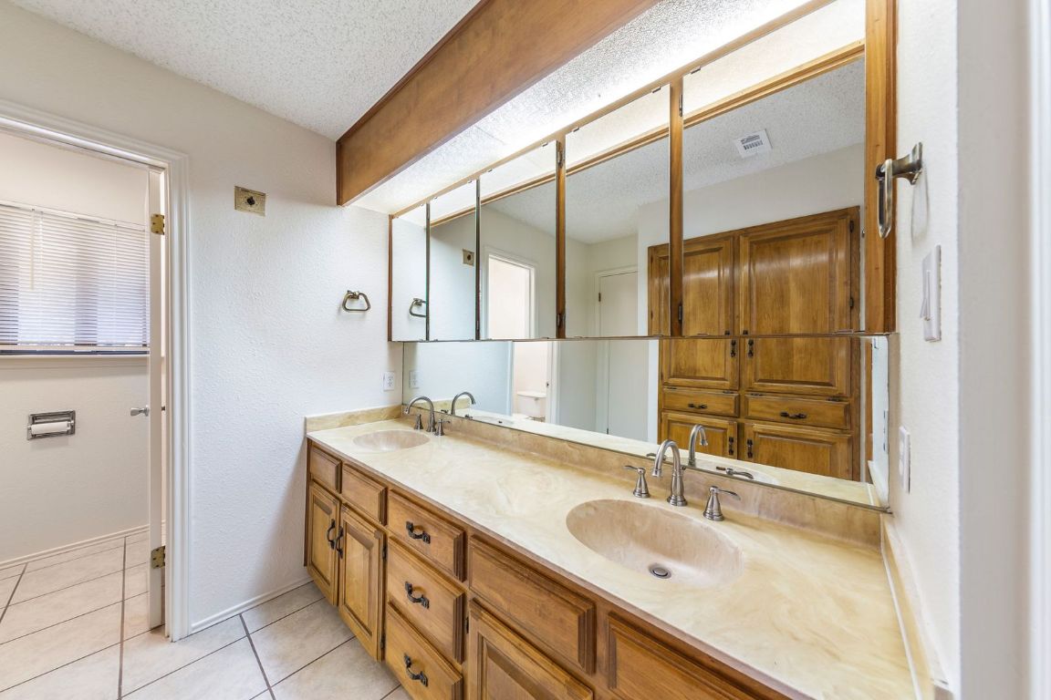 8501 Fathom Circle, Unit A Austin, TX 78750 - Photo 19 of 30 a bathroom with a granite countertop double vanity sink and mirror
