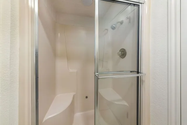 a bathroom with a glass shower door