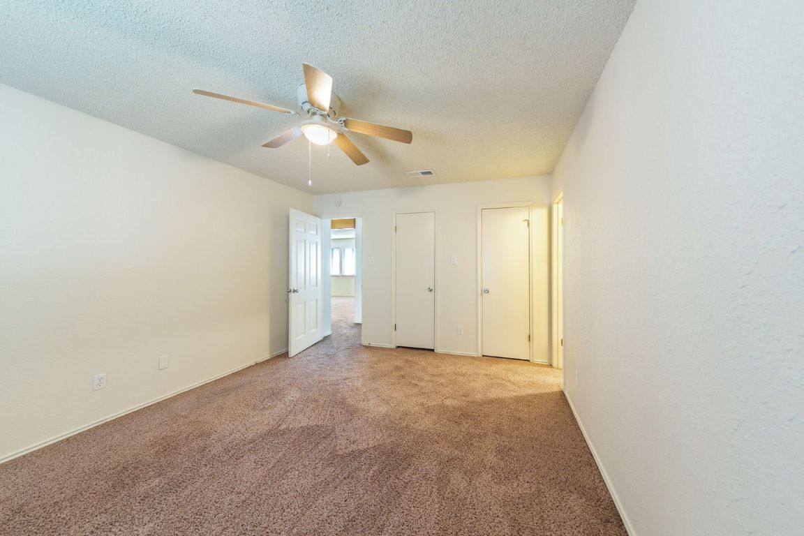 8501 Fathom Circle, Unit A Austin, TX 78750 - Photo 23 of 30 a view of an empty room and a ceiling fan