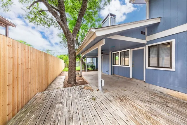 a view of a house with wooden floor and fence
