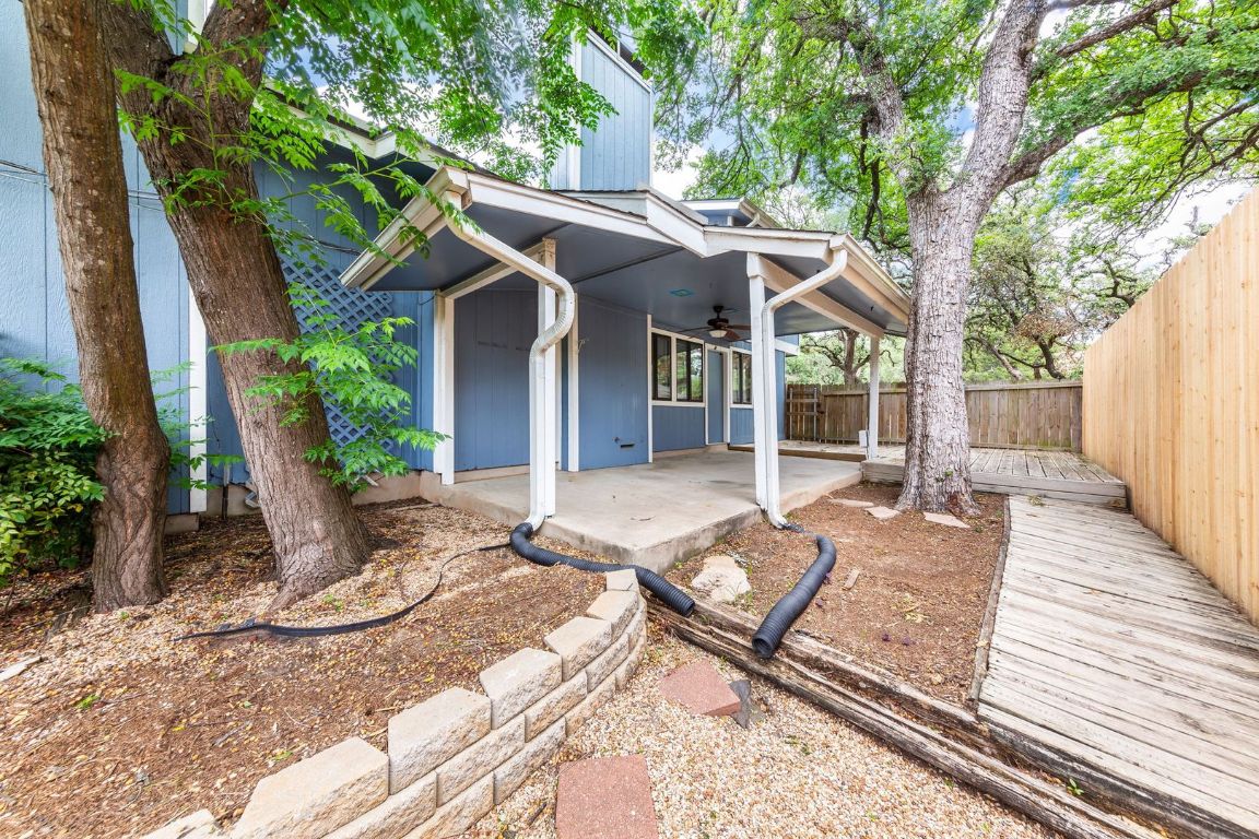 8501 Fathom Circle, Unit A Austin, TX 78750 - Photo 27 of 30 a view of a patio with table and chairs potted plants and large tree