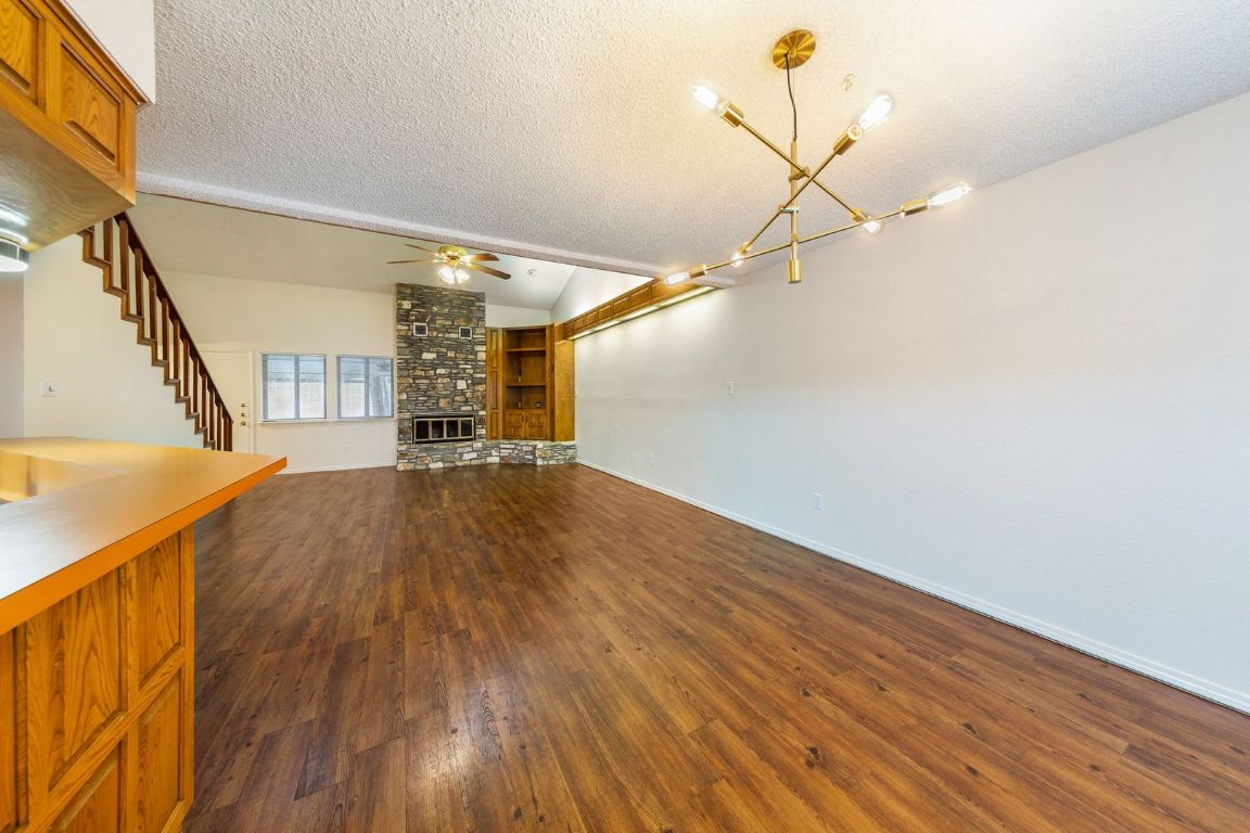 8501 Fathom Circle, Unit A Austin, TX 78750 - Photo 7 of 30 a view of a room with wooden floor and white walls
