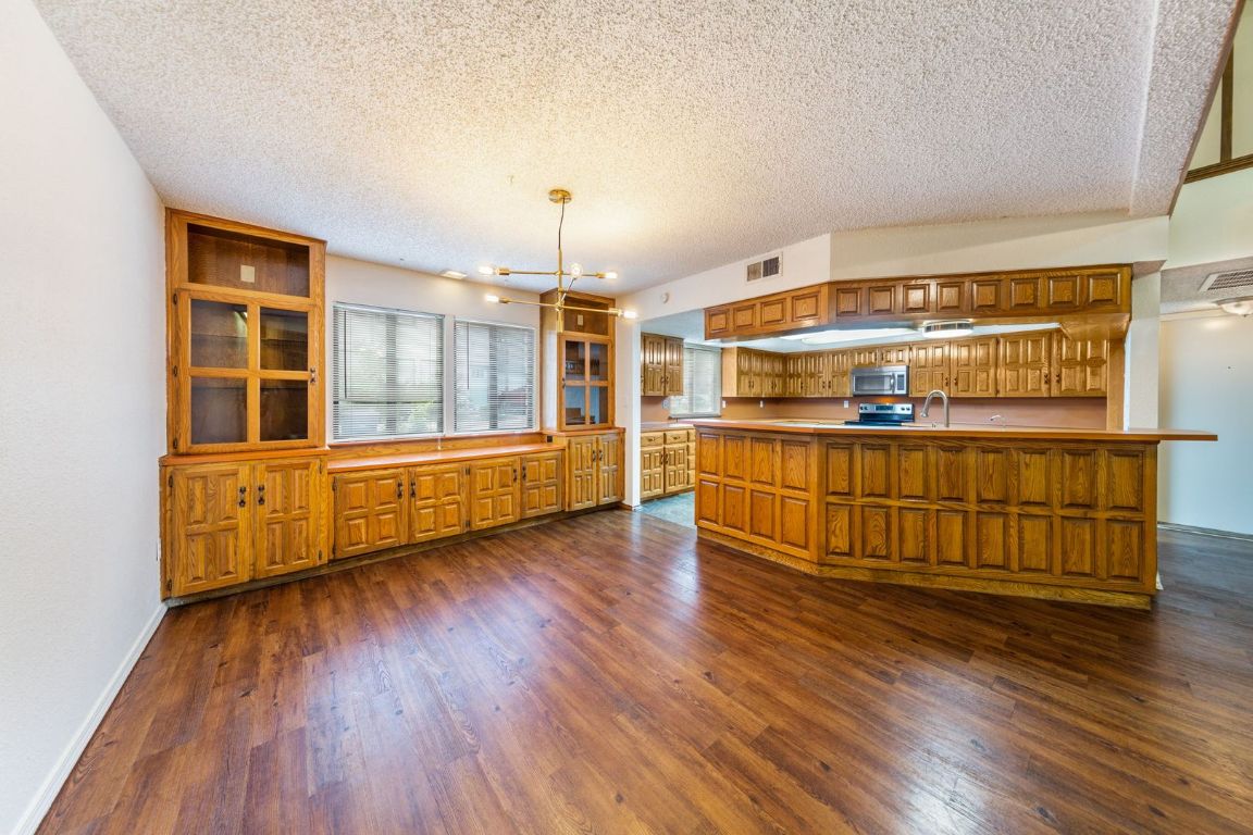 8501 Fathom Circle, Unit A Austin, TX 78750 - Photo 8 of 30 a room with wooden floors and natural light
