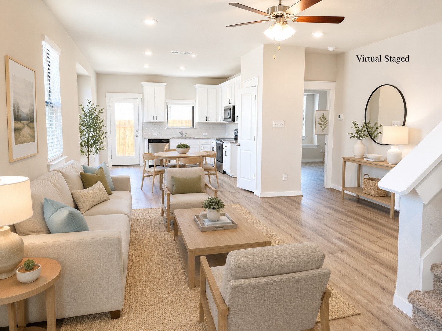 147 Waterside Road, Unit A Buda, TX 78610 - Photo 3 of 27 An inviting open-concept living area boasts a modern kitchen and warm wood-look flooring.