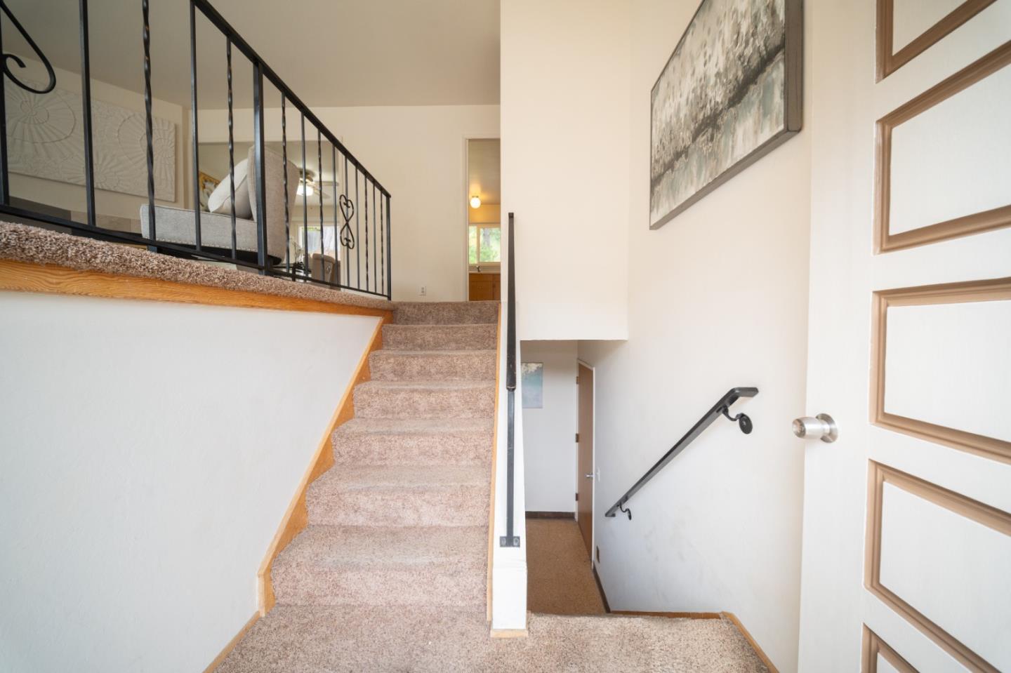 1287 Lerida Way Pacifica, CA 94044 - Photo 12 of 52 a view of staircase with lots of frames on wall and a window