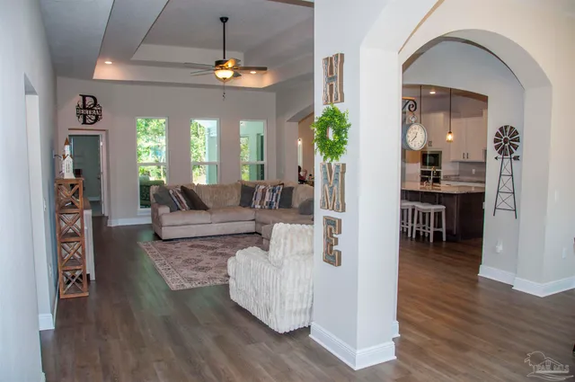 a living room with furniture and wooden floor