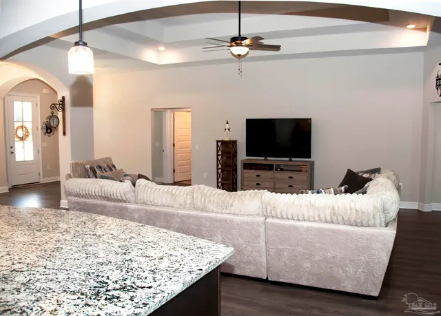 a living room with furniture and wooden floor