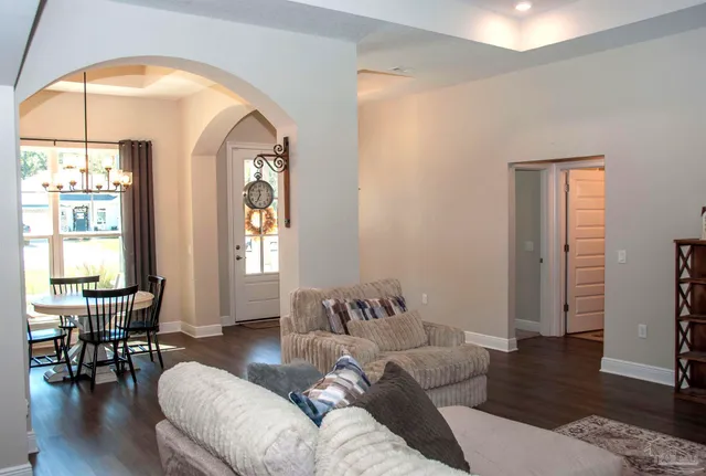 a living room with furniture and white walls