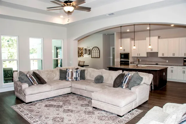 a kitchen with stainless steel appliances granite countertop a kitchen island hardwood floor sink stove and refrigerator