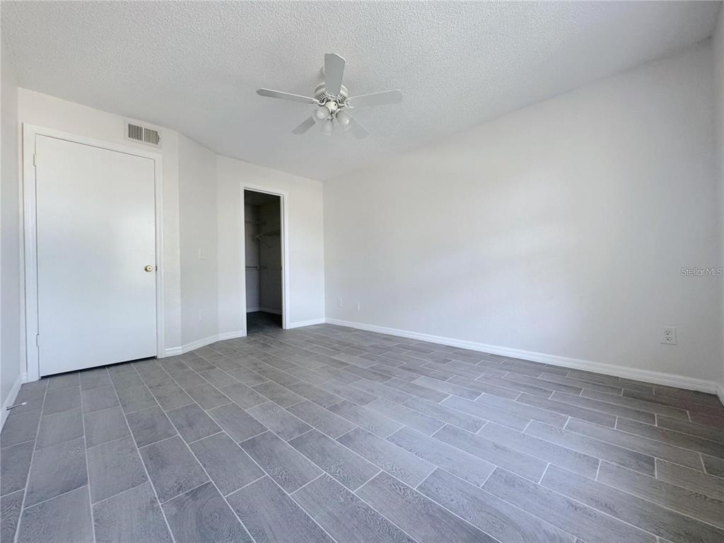 1013 South Hiawassee Road, Unit 3635 Orlando, FL 32835 - Photo 11 of 18 a view of an empty room with wooden floor