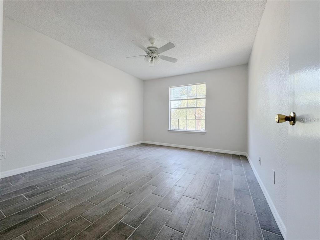 1013 South Hiawassee Road, Unit 3635 Orlando, FL 32835 - Photo 12 of 18 wooden floor in an empty room with a window