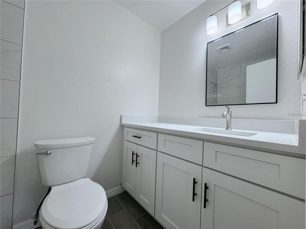 1013 South Hiawassee Road, Unit 3635 Orlando, FL 32835 - Photo 15 of 18 a bathroom with a toilet sink and mirror