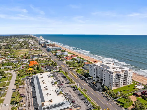 a view of a hallway with wooden floor and a glass door