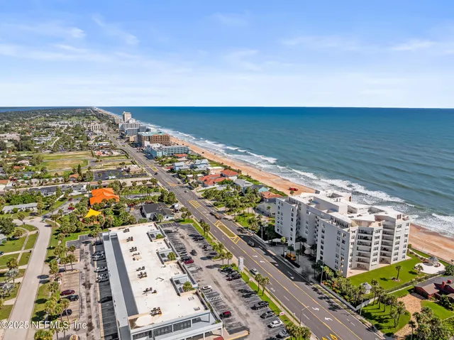 a view of a hallway with wooden floor and a glass door