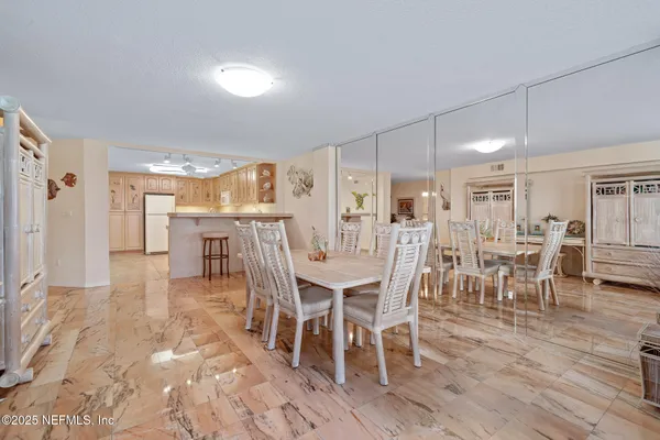 a kitchen with a refrigerator a stove top oven and white cabinets