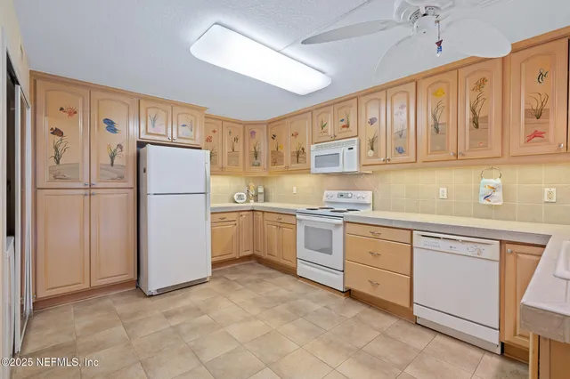 a kitchen with a stove cabinets and refrigerator