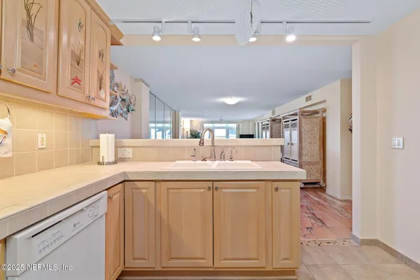 a spacious bedroom with a bed and a flat screen television