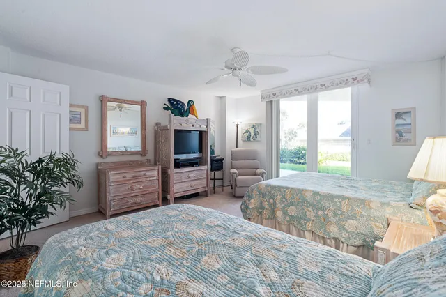 a spacious bedroom with a bed a couch and dresser