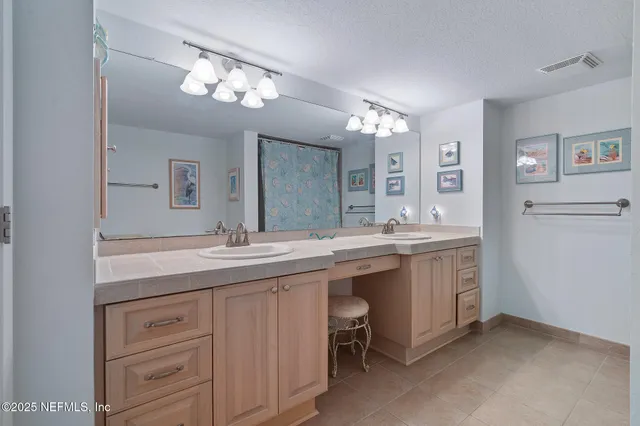 a bathroom with a sink a toilet a mirror and shower