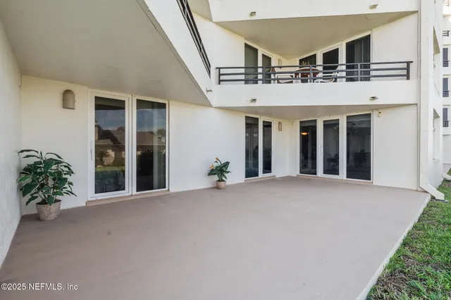 a view of a house with swimming pool and sitting area