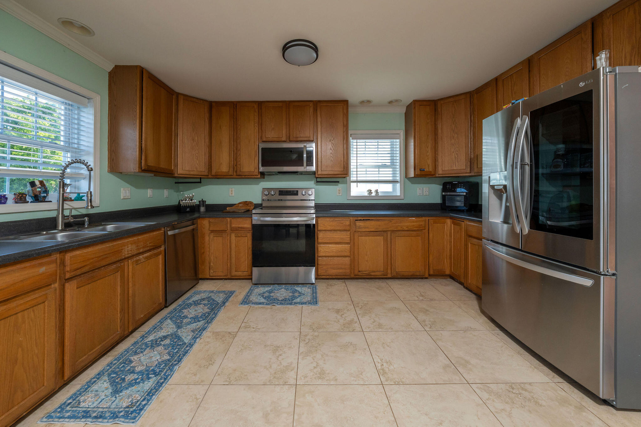 27 Avenue D Key Largo, FL 33037 - Photo 12 of 69 a kitchen with stainless steel appliances granite countertop a sink stove refrigerator and cabinets
