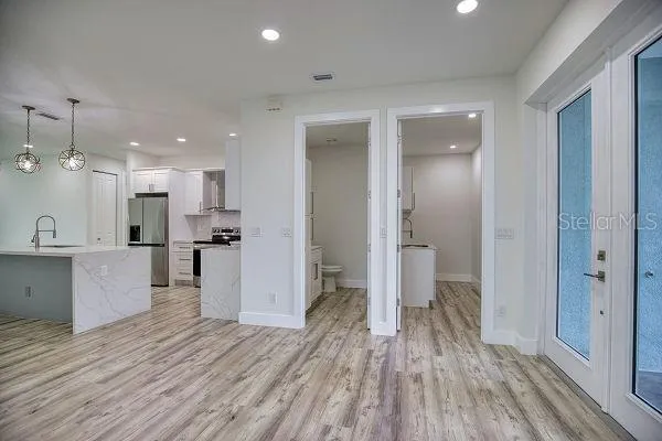 a kitchen with a refrigerator and a sink